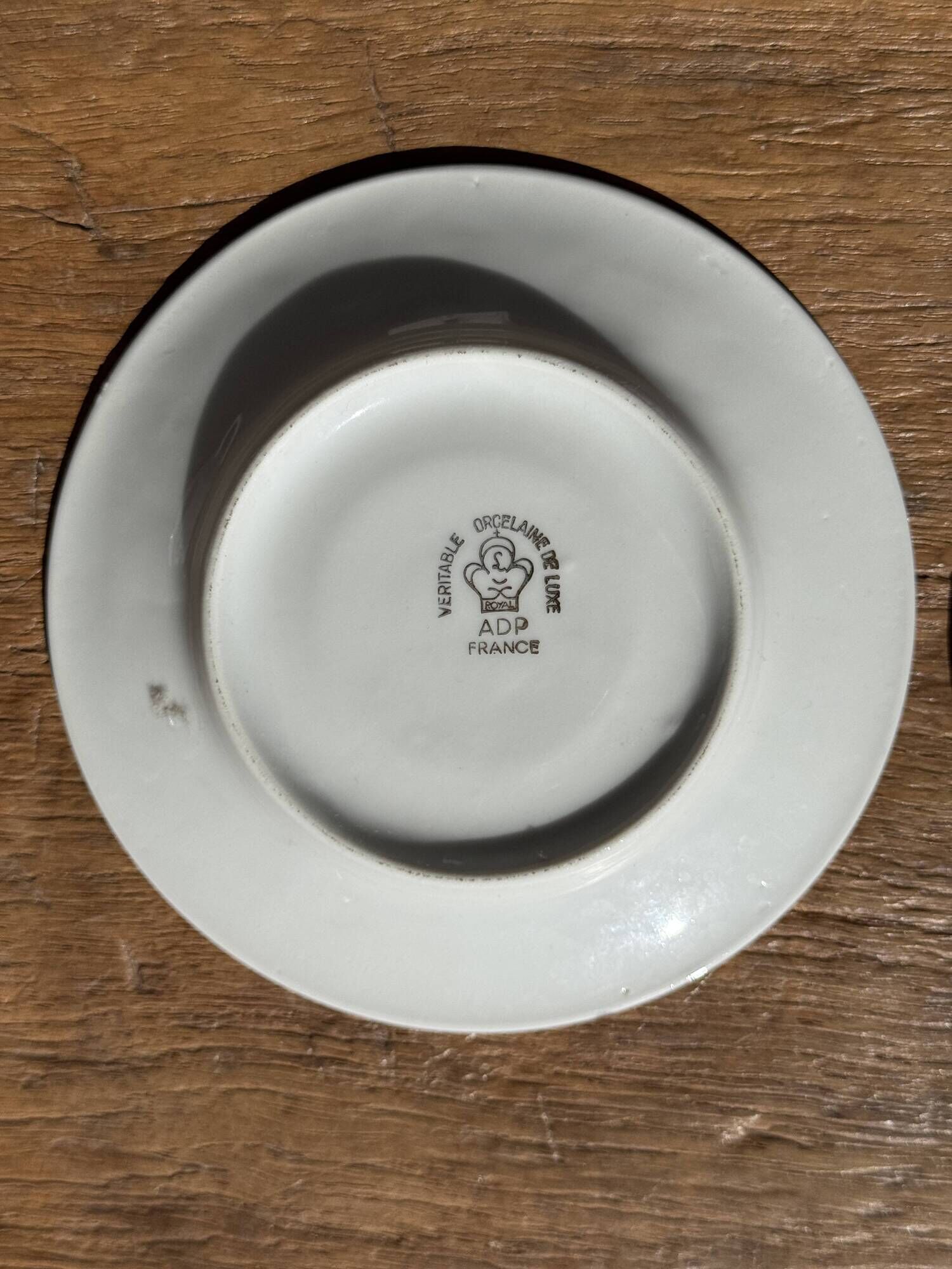 Pair of white porcelain cups from ADP France with a floral pattern and their s
