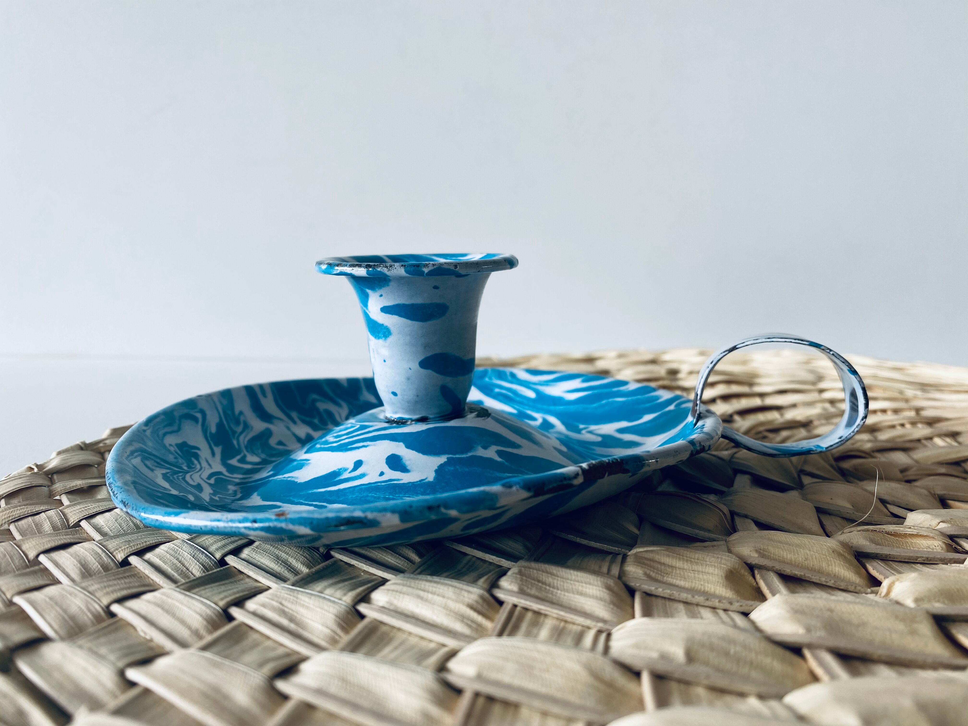 Old enamelled metal candlestick