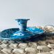 Old enamelled metal candlestick