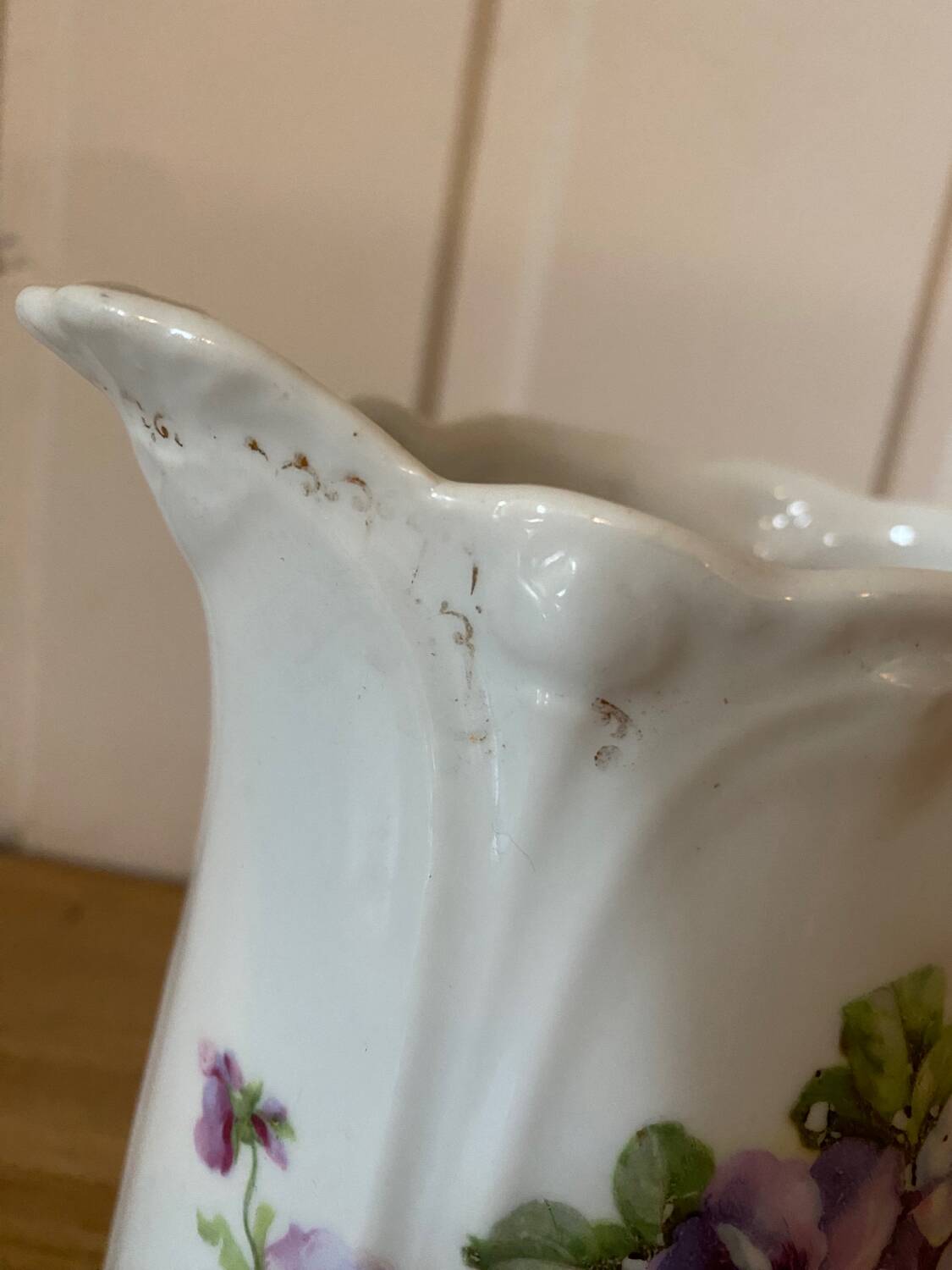 Old ceramic pitcher decorated with flowers