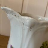 Old ceramic pitcher decorated with flowers