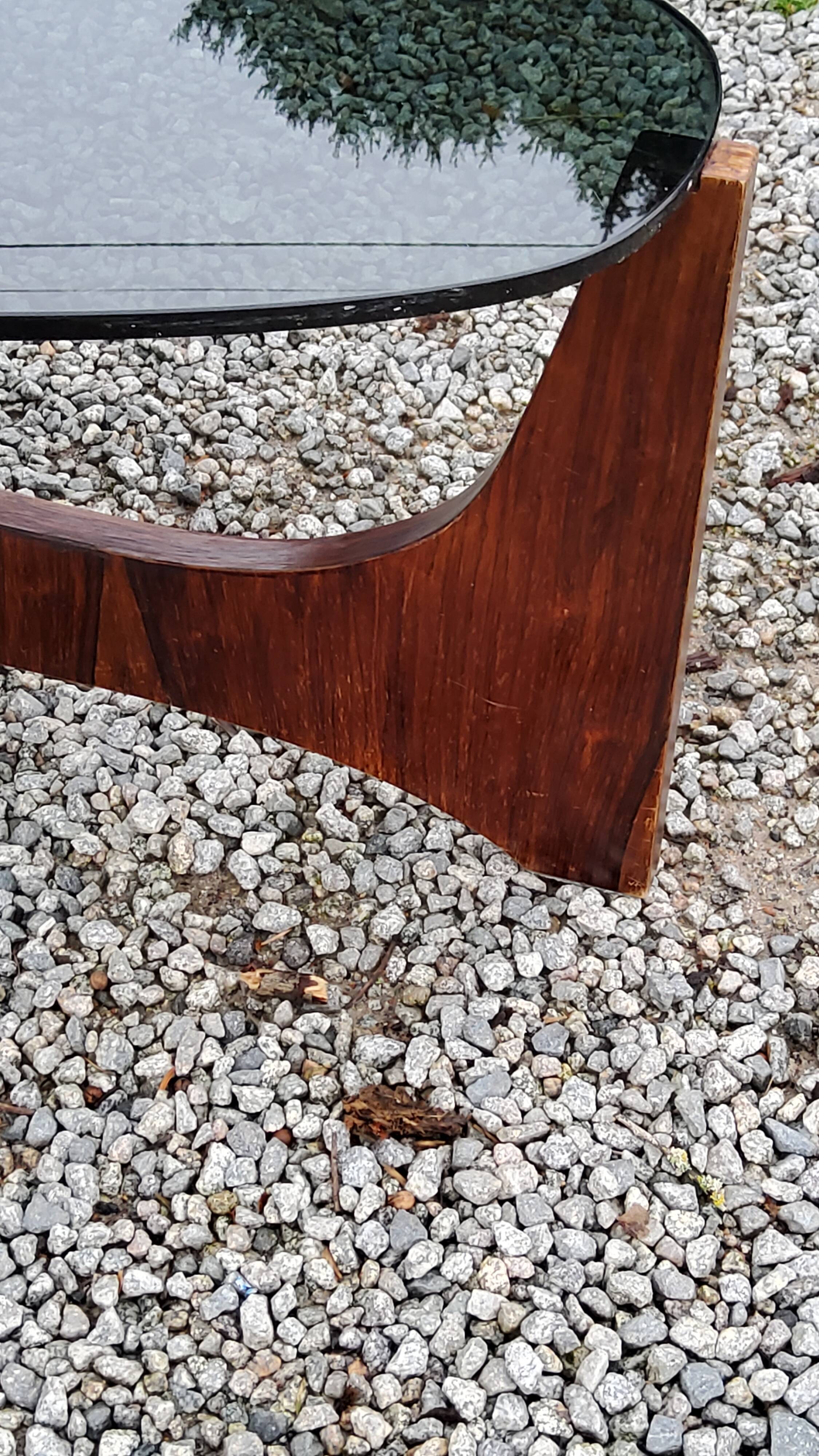 Designer coffee table by Hugues Poignant in rosewood and smoked glass from the 70s