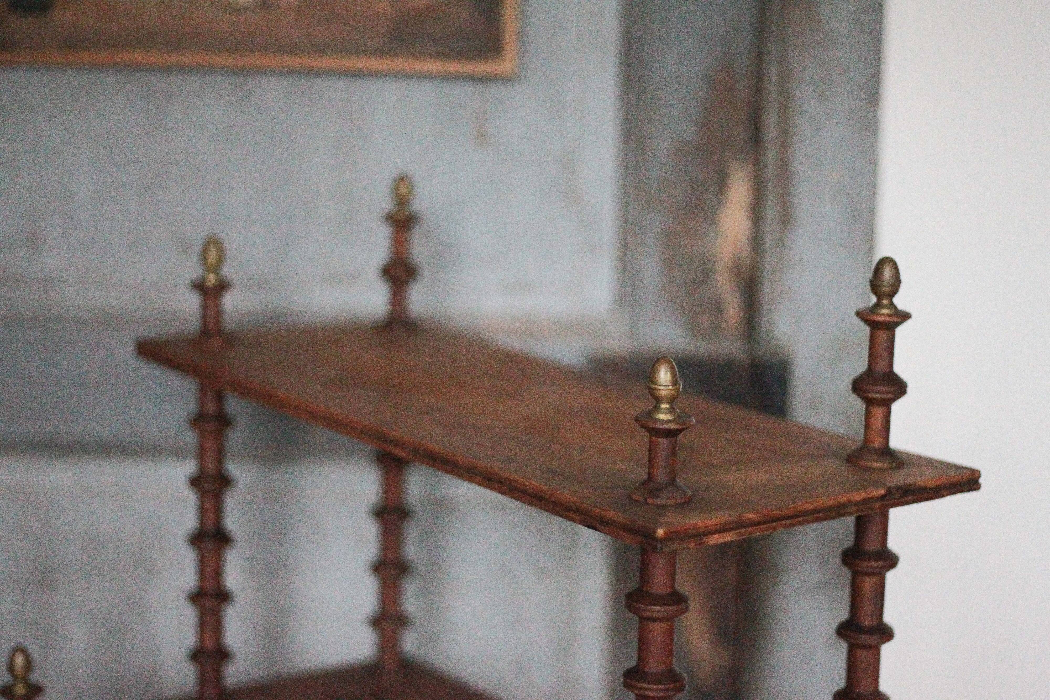 Napoleon III spool shelf, floor-standing shelf with brass tips.