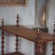 Napoleon III spool shelf, floor-standing shelf with brass tips.