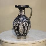 A jar of water pitcher made of tamgroute pottery handmade and adorned with bones.