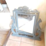 Rocking patinated wood mirror