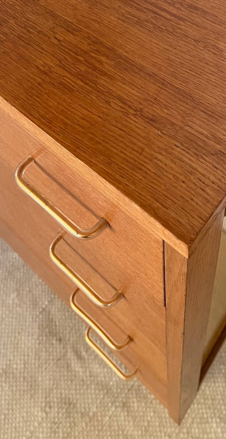 Vintage 1960s chest of drawers with covered handles.