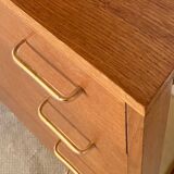 Vintage 1960s chest of drawers with covered handles.