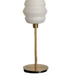 Table lamp with a vintage white glass globe and a golden base