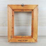 Patinated golden frame in wood and stucco