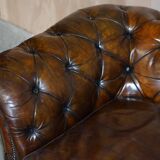 Victorian Chesterfield leather upholstered canapé with feather cushions.
