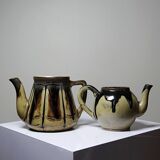 A pair of small vintage teapots in the Art Deco style reminiscent of Denbac.