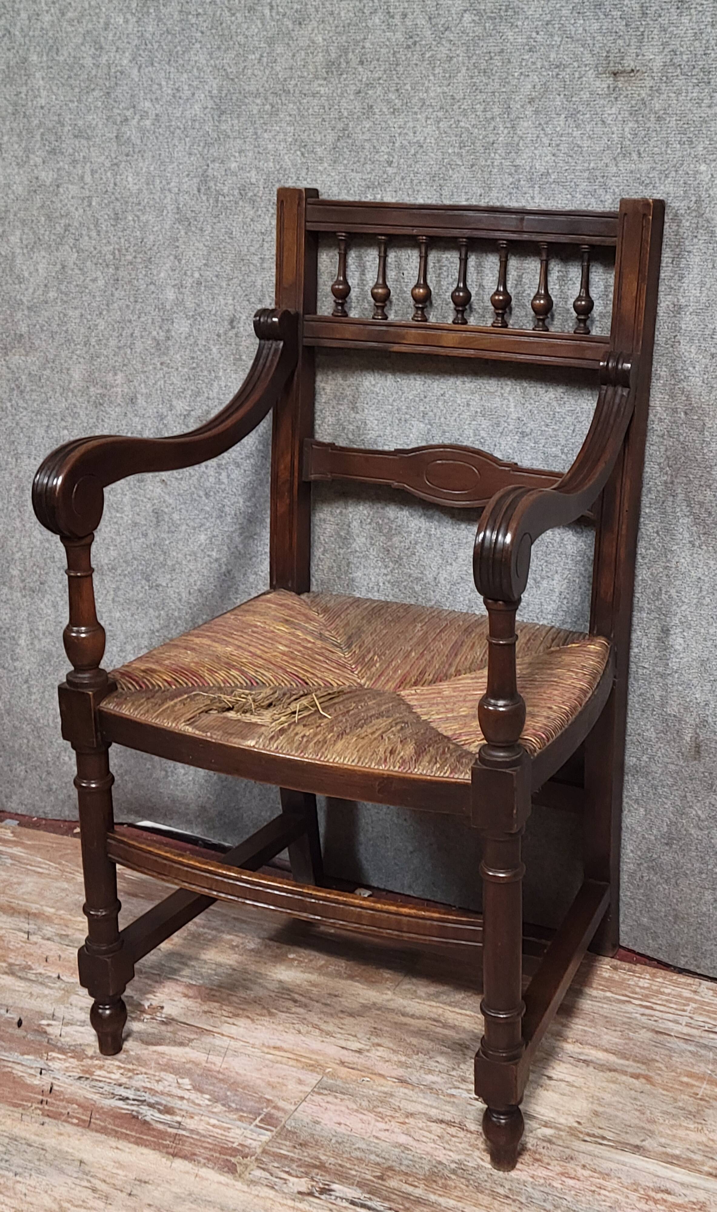Renaissance-style armchair in solid wood, featuring a columned back
