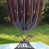 Large blown glass and wrought iron vase on shower stand