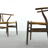 Pair of CH24 wishbone dining chairs by Hans Wegner for Carl Hansen Denmark