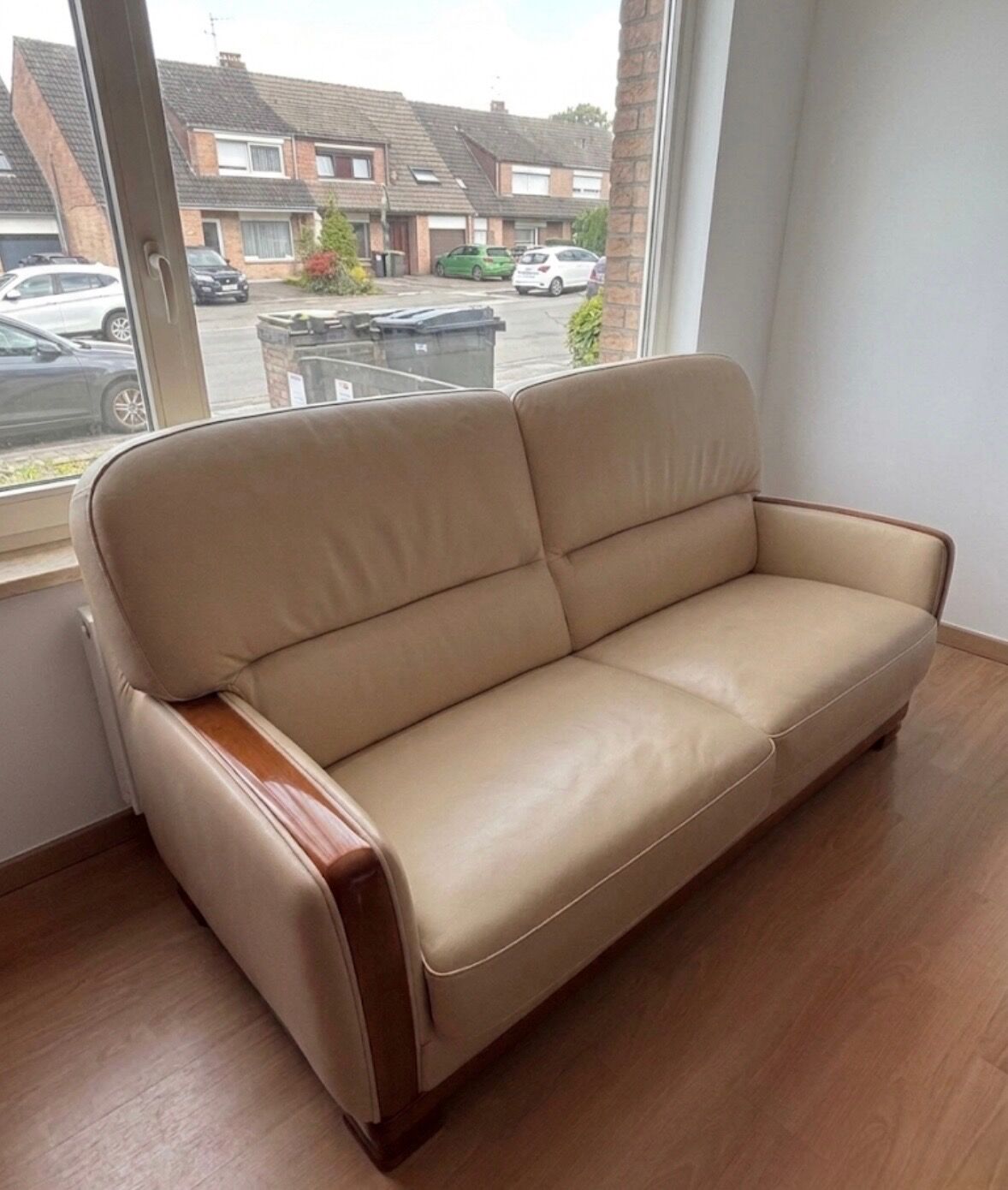 Beige leather sofa with solid wood frame