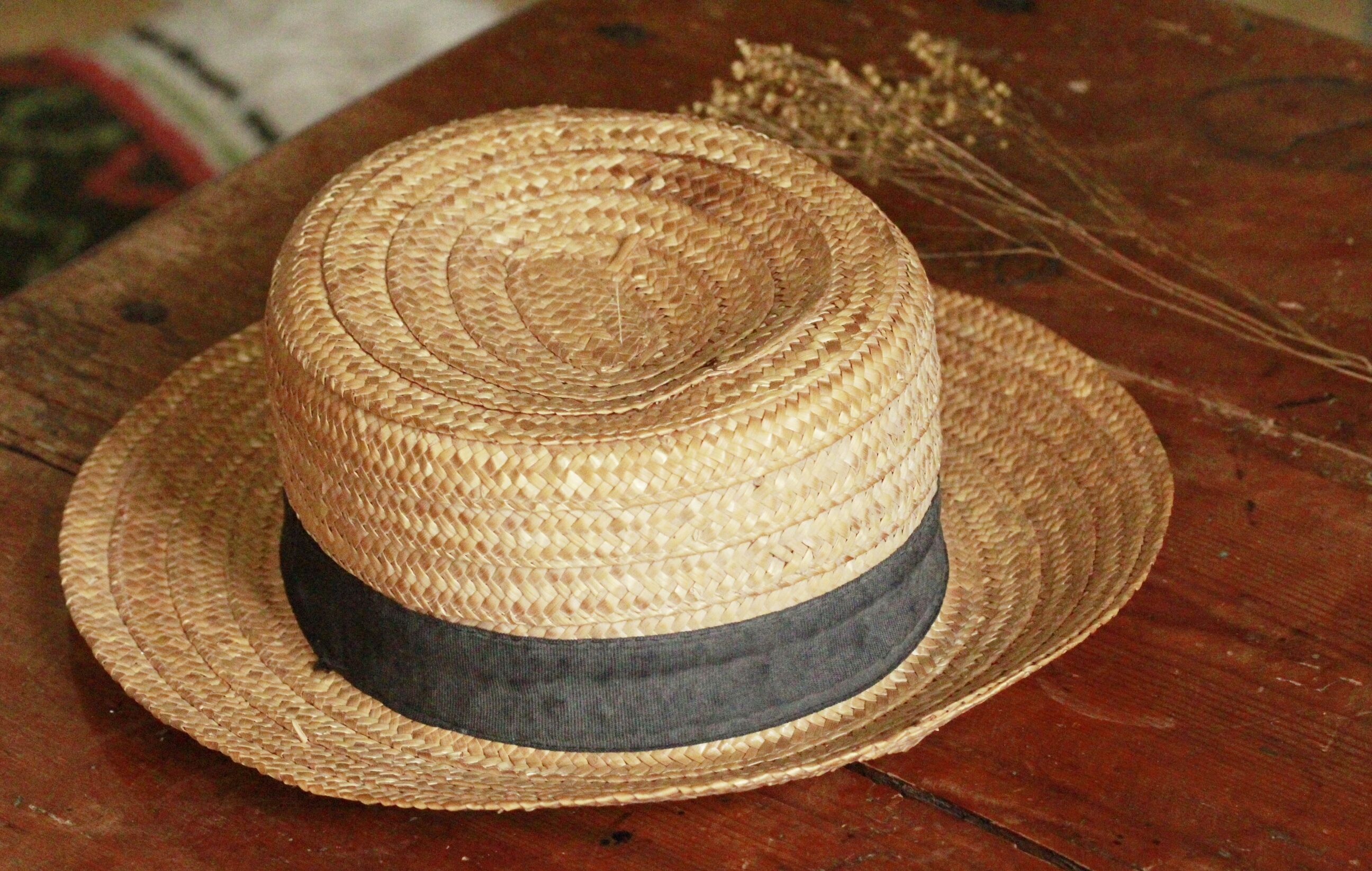 Old straw hat with black ribbon
