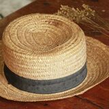 Old straw hat with black ribbon