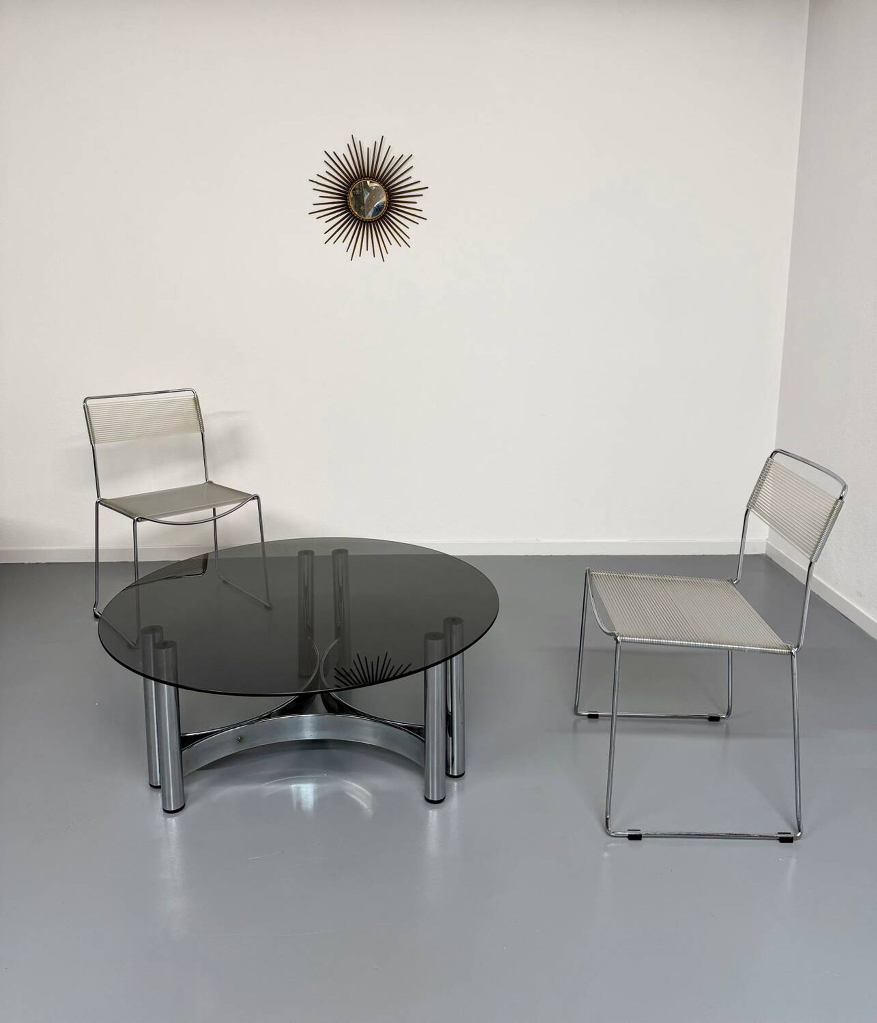 Round coffee table in smoked glass and chrome steel, 1970s design.