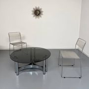Round coffee table in smoked glass and chrome steel, 1970s design.