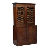 19th-century hardwood library with bronze metal doors and a chest of drawers.