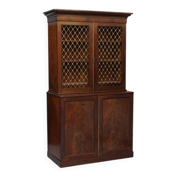 19th-century hardwood library with bronze metal doors and a chest of drawers.