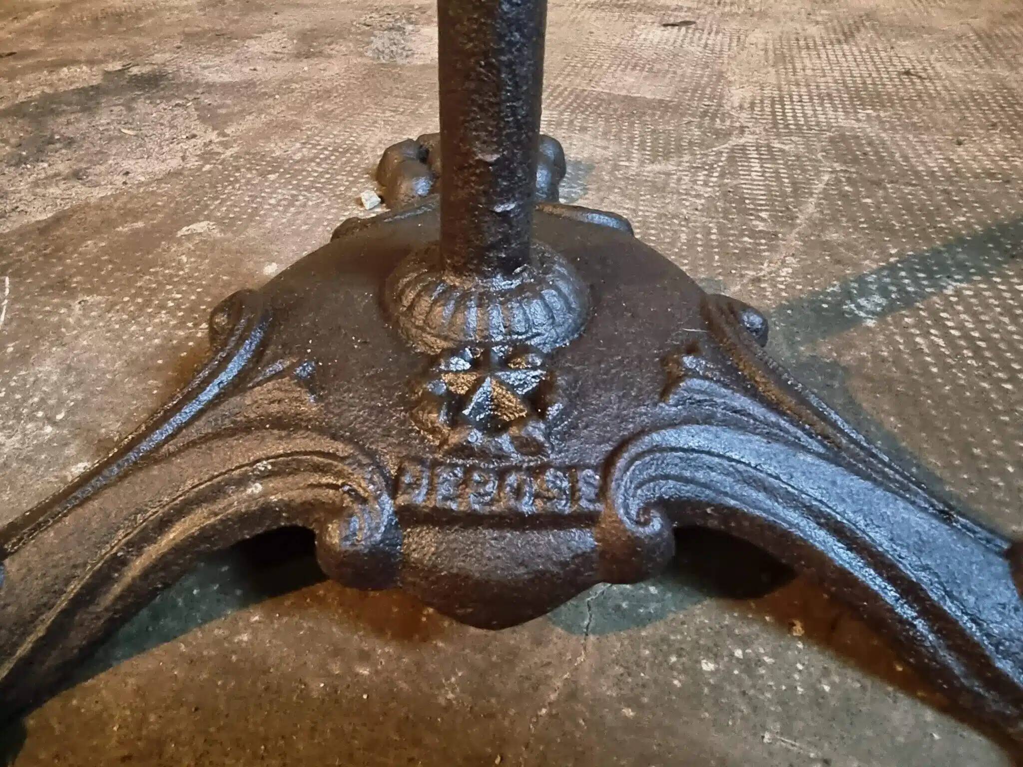 Old French bistro table with a marble top and a cast iron base.