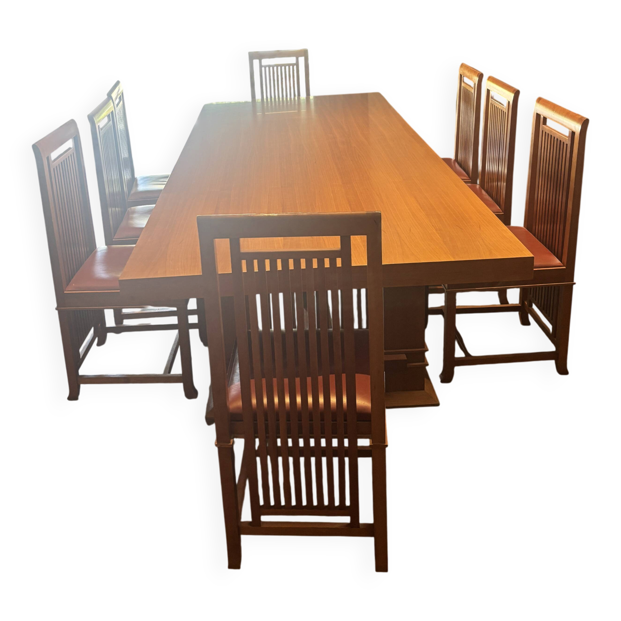"Frank Lloyd Wright set with a table and its eight chairs."
