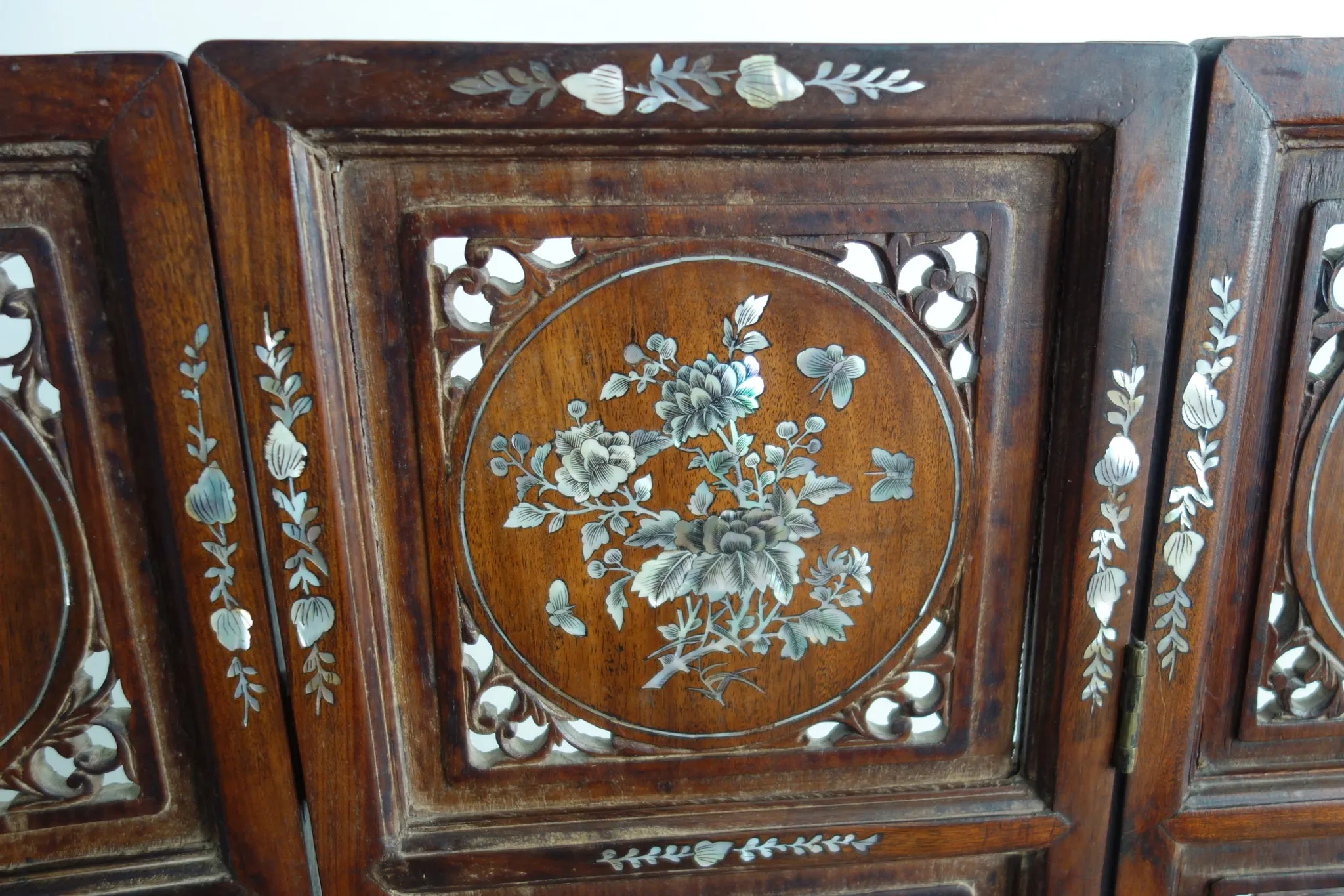 Asian screen in carved wood and mother-of-pearl marquetry.