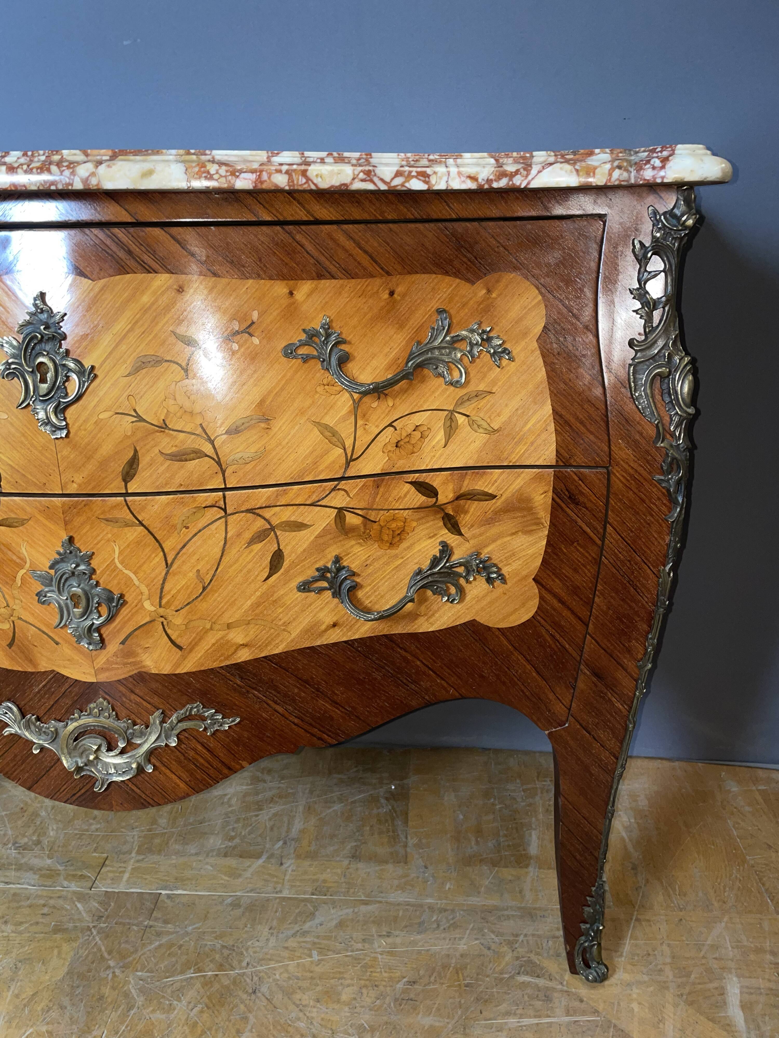 Louis XV style commode with floral marquetry decoration.
