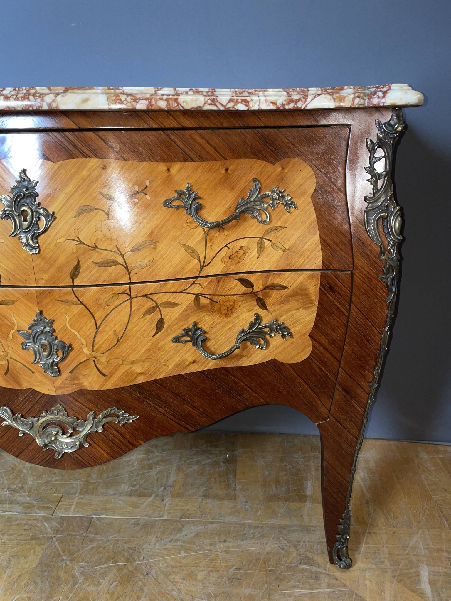 Louis XV style commode with floral marquetry decoration.