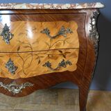 Louis XV style commode with floral marquetry decoration.