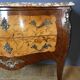 Louis XV style commode with floral marquetry decoration.