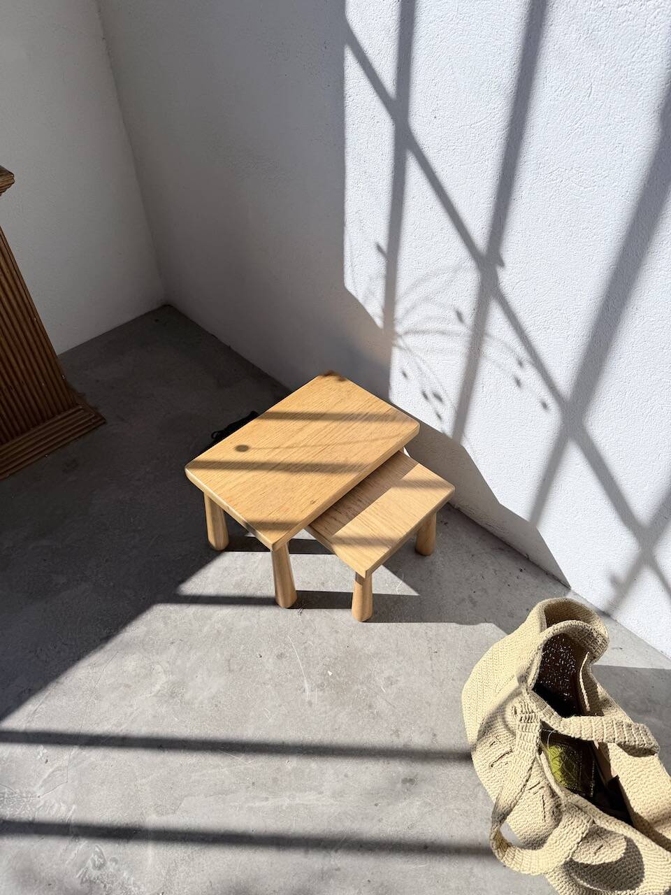 Two stools or small nesting tables in light oak.