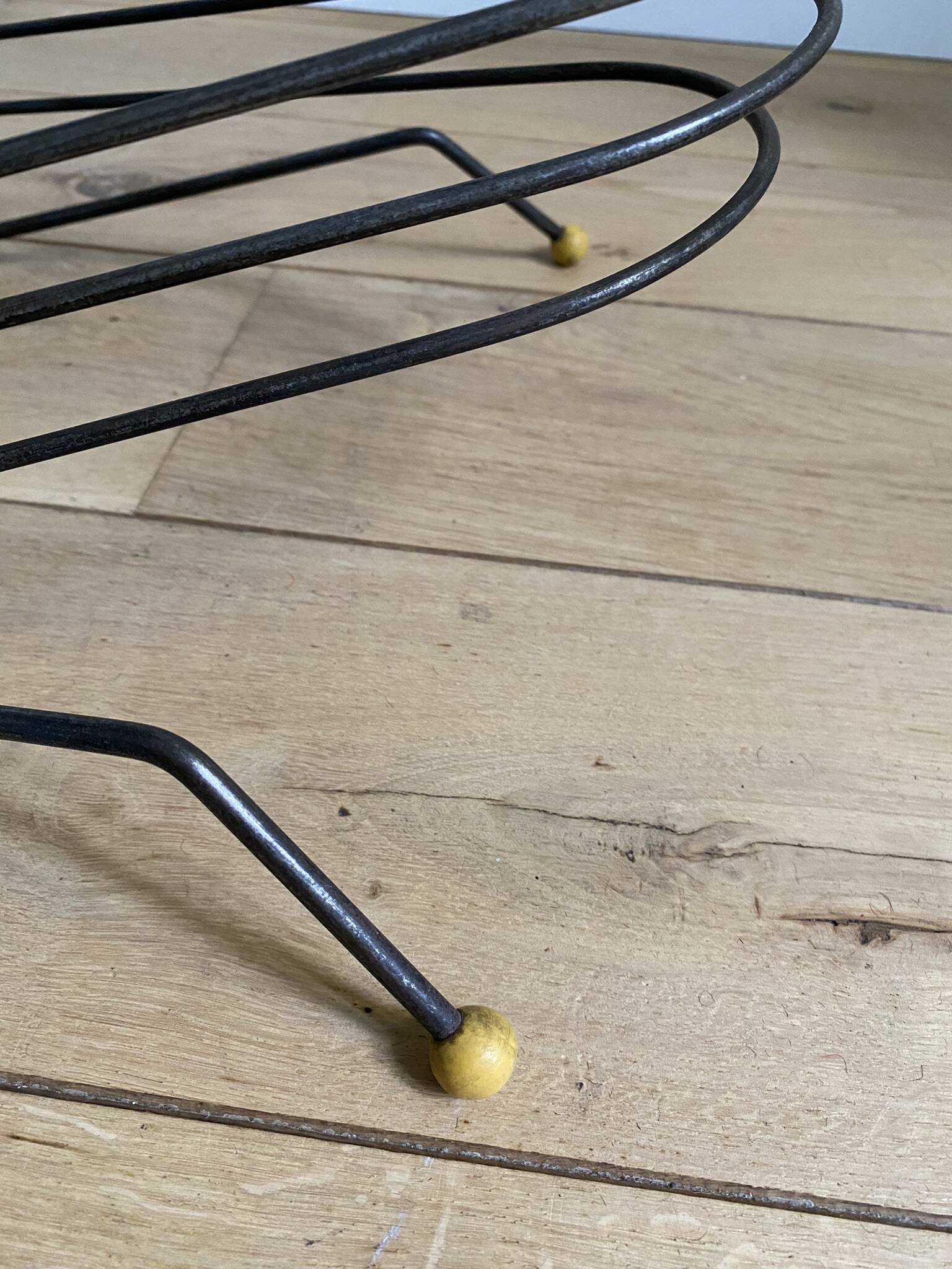 Black metal vinyl record holder and yellow scoubidou from the 60s