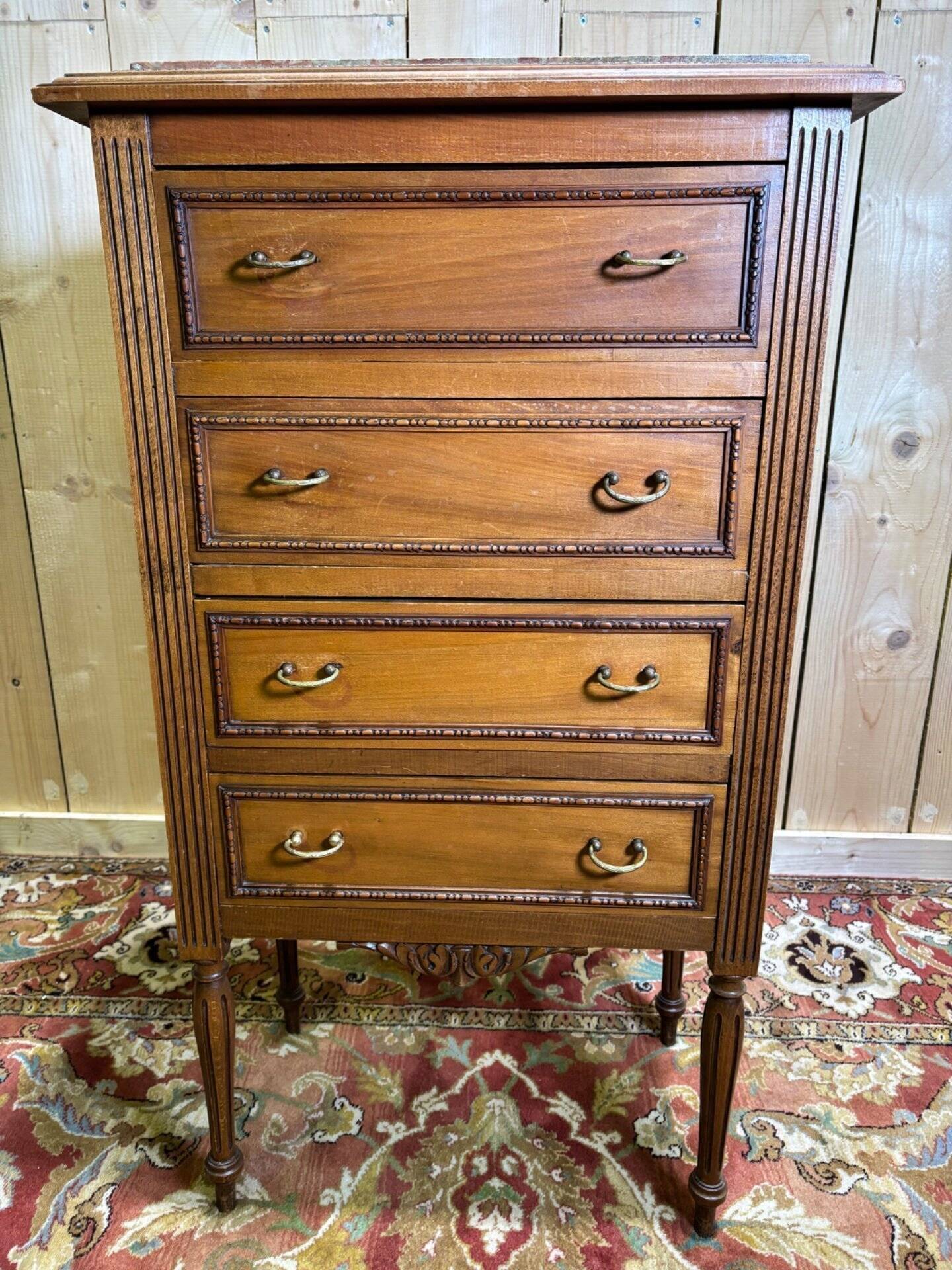 Louis XVI style molded and carved walnut chest of drawers