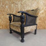 Old armchair upholstered in velvet, carved and caned wood