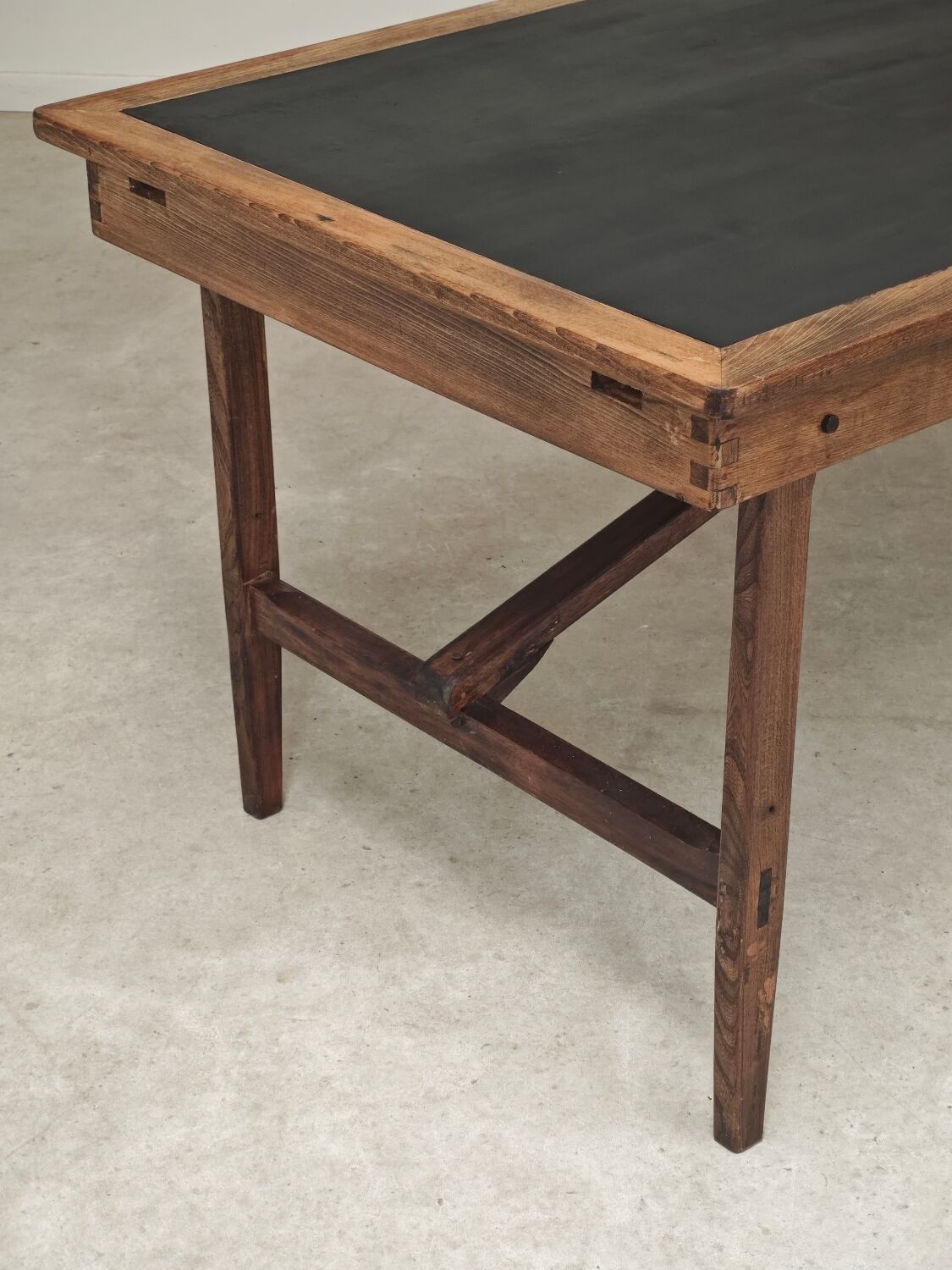Vintage workshop folding table in oak with a hand-patinated black top.