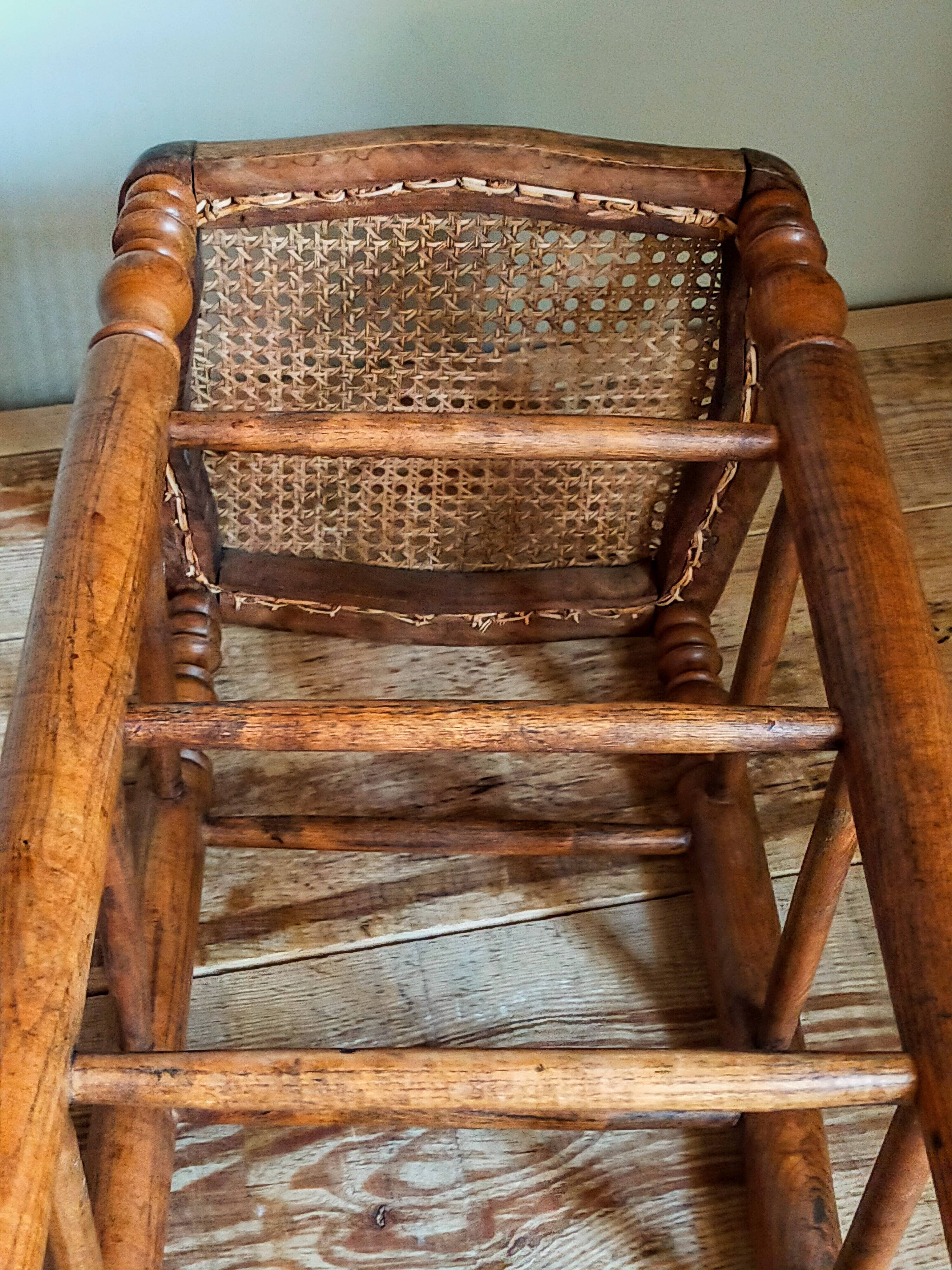 Antique stool with cane and turned wood