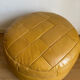 2 poufs moutarde patchwork en cuir de Sède
