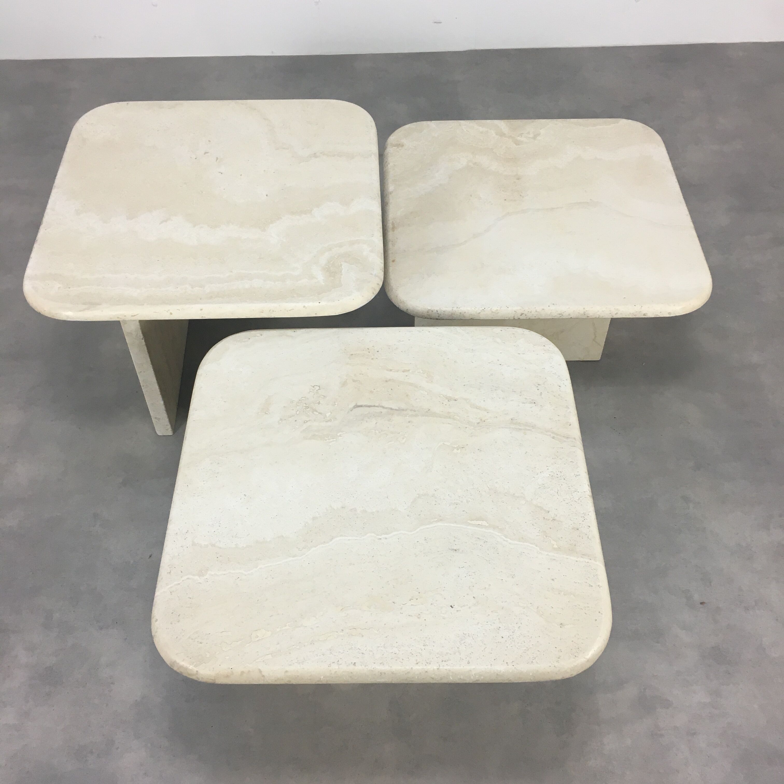Three travertine trundle coffee tables