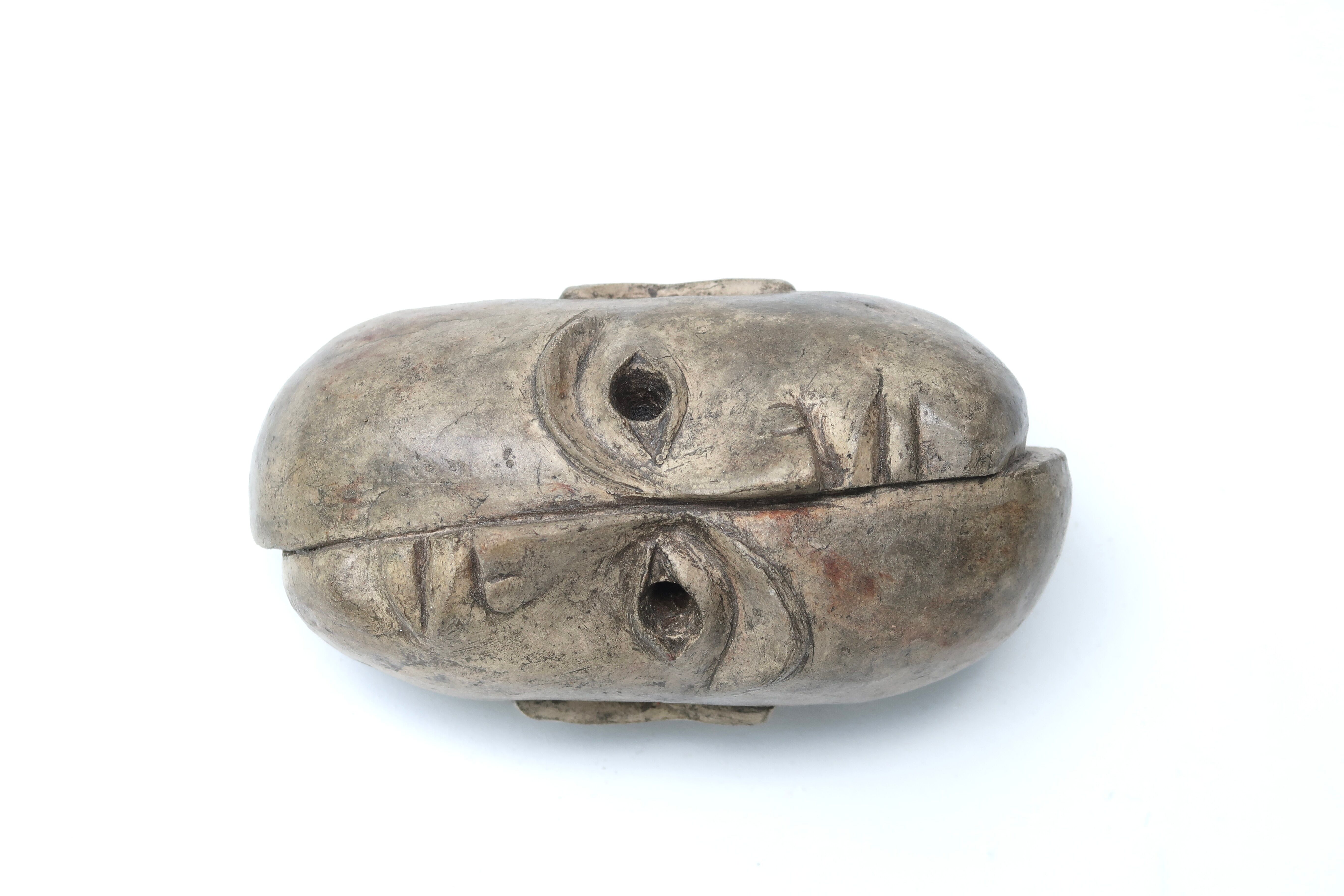 Patinated plaster sculpture paper press: Inverted faces
