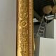 Miroir doré style Restauration à décor de palmettes étirées