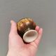 A set of ceramic candle holders in earthy colours.