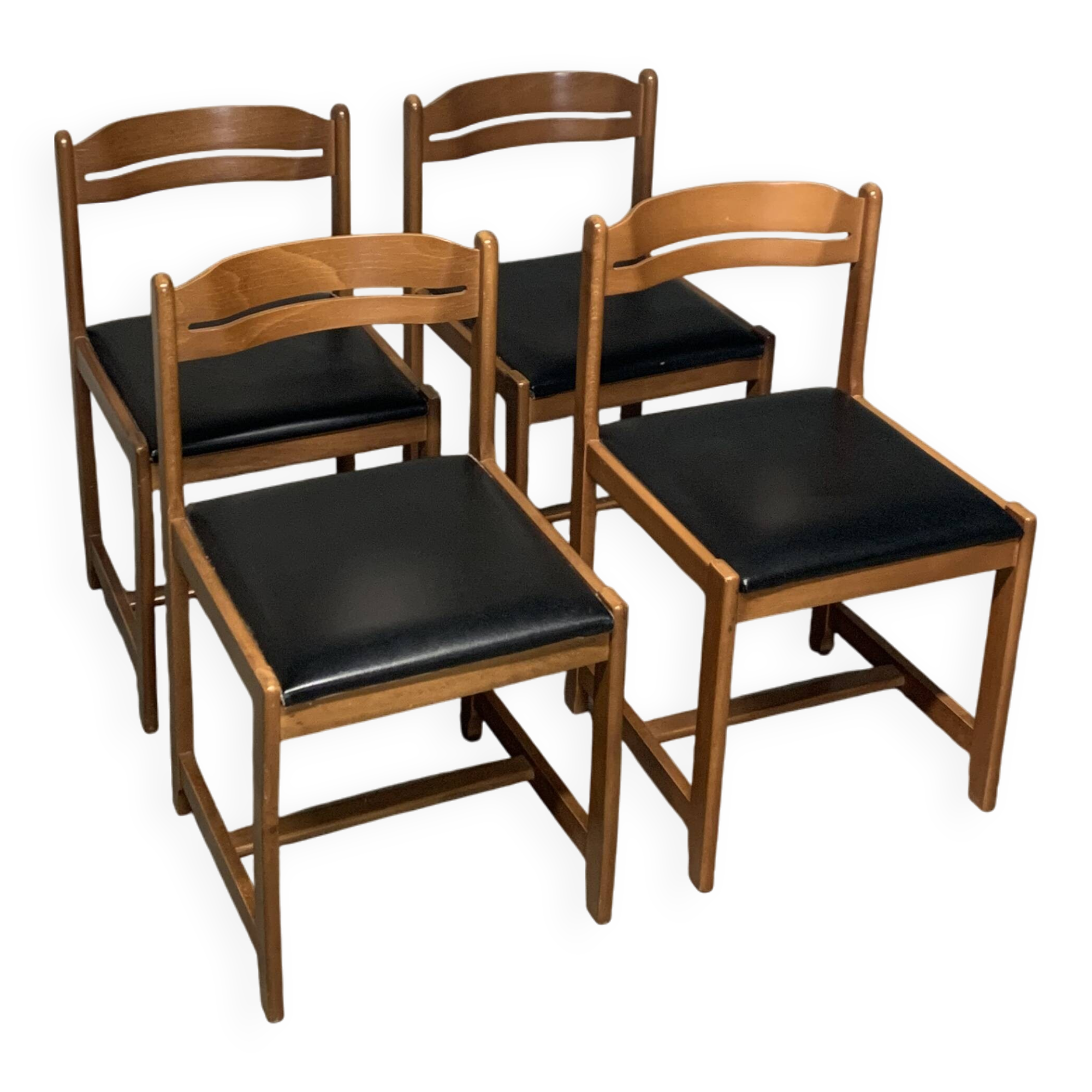 Set of four vintage chairs upholstered in retro design faux leather.