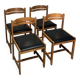 Set of four vintage chairs upholstered in retro design faux leather.