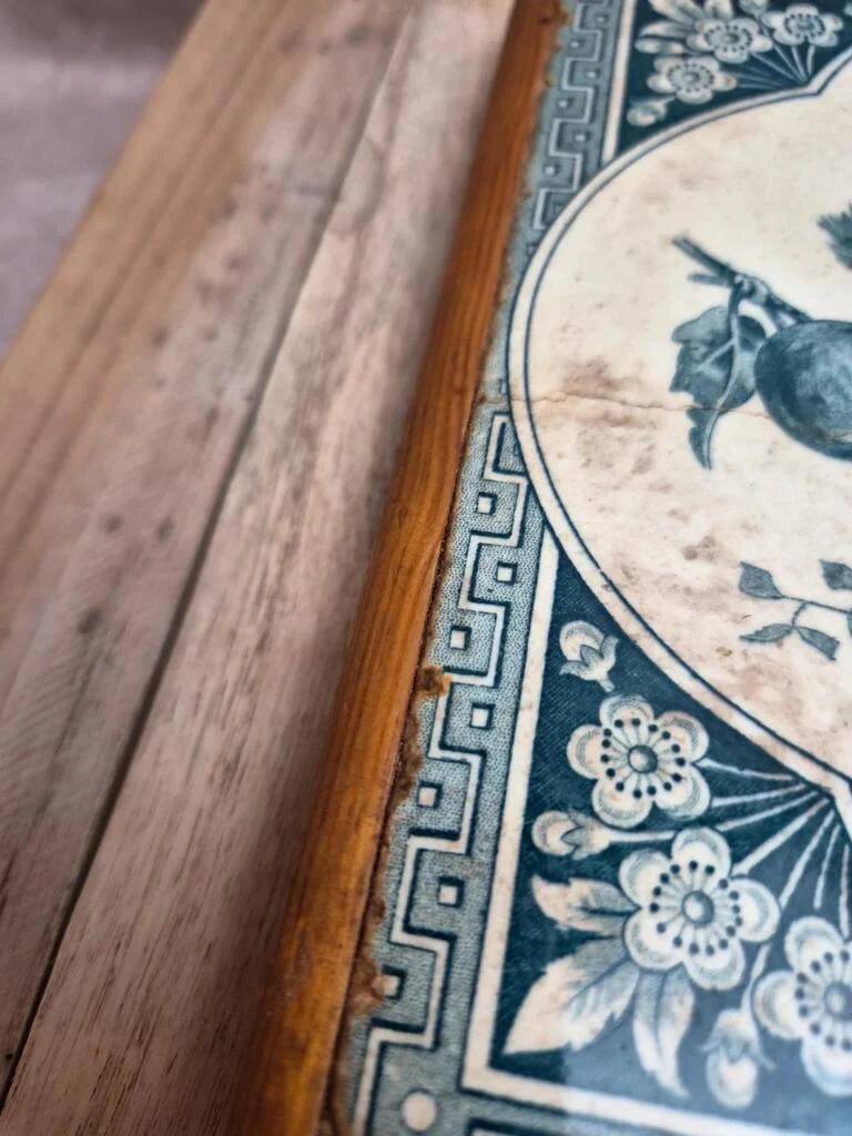 Antique trivet in Gien tile with blue bird decoration – wooden border