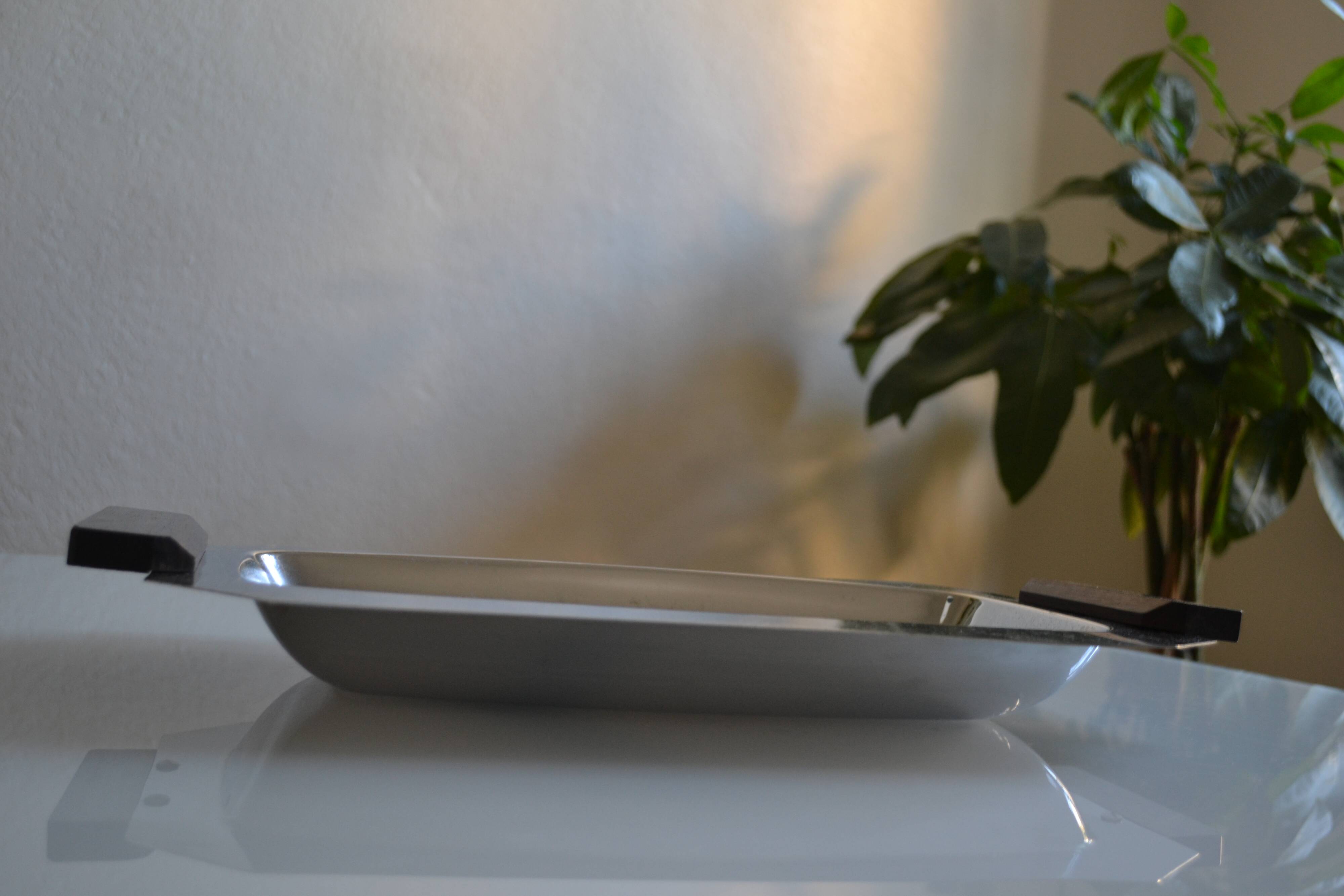 Art Deco serving dish in chrome metal with ebony handles.