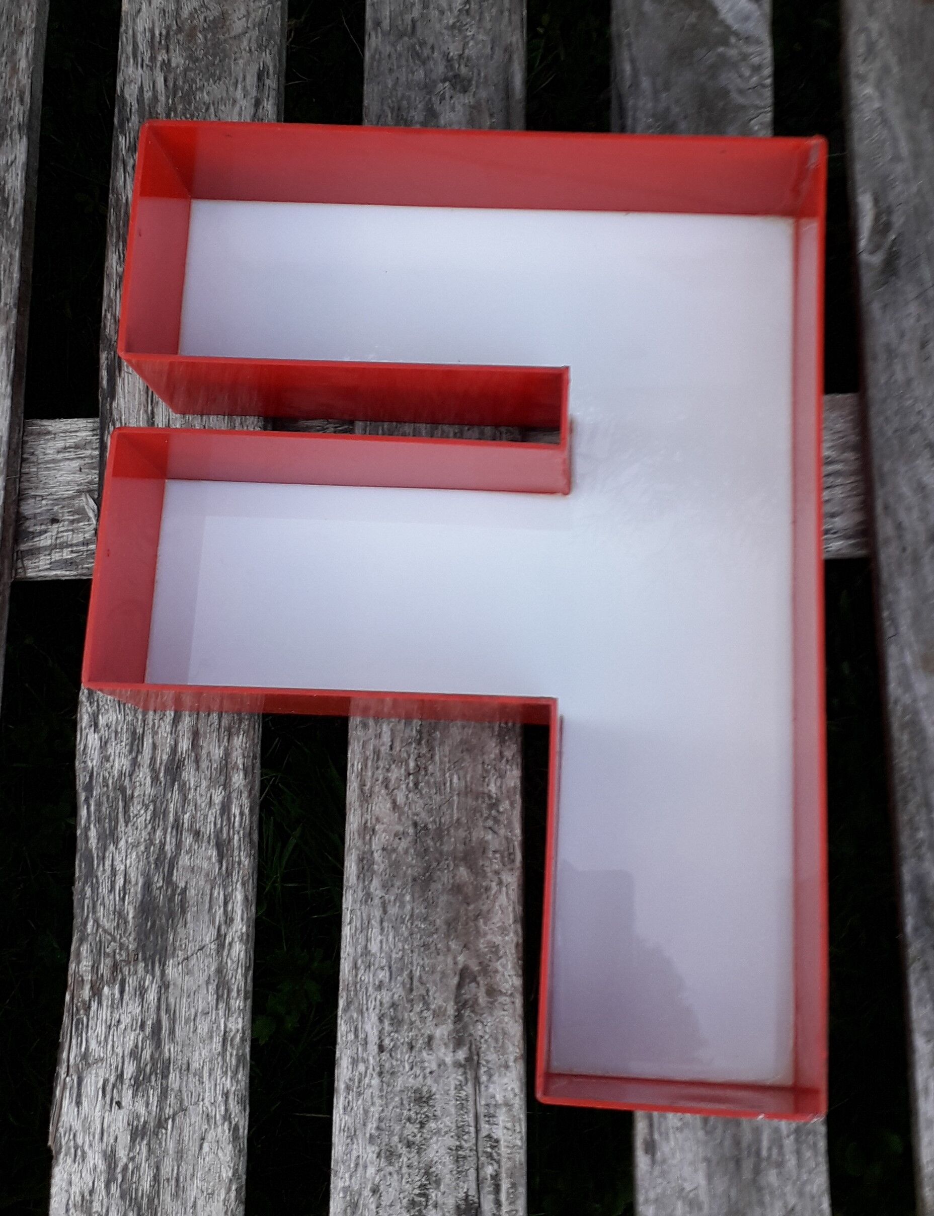 Red and white sign "f" letter