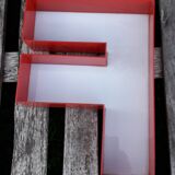 Red and white sign "f" letter